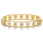 An 18K yellow gold bracelet with flower designs covered in diamonds