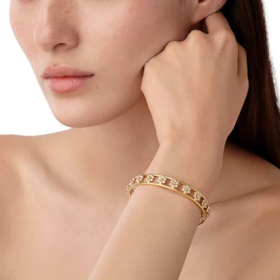 woman wearing Temple St Clair 18K gold Fiori bracelet with diamonds