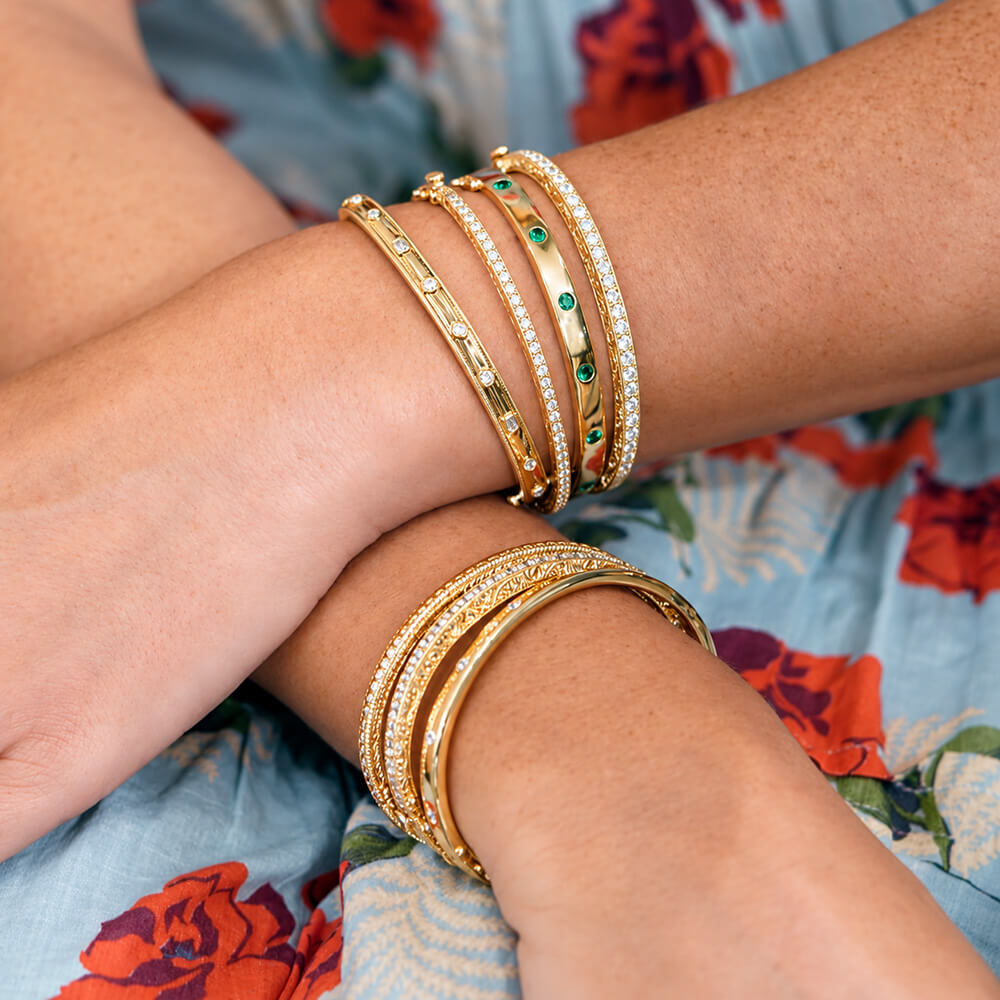 woman wearing 18k gold and diamond bracelets designed by Penny Preville 
