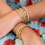 woman wearing 18k gold and diamond bracelets designed by Penny Preville 