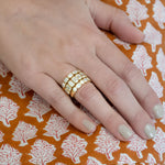 woman wearing 18k gold diamond rings