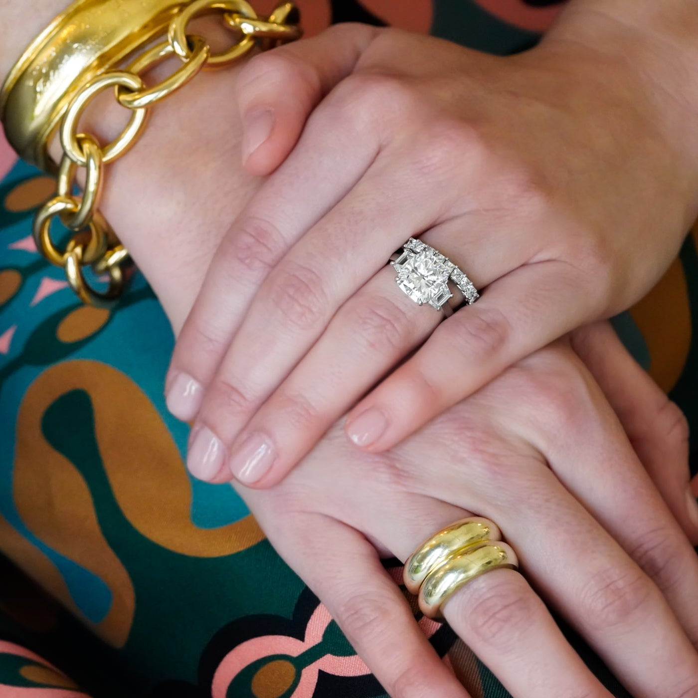 woman wearing 14K gold dome rings and other gold and diamond jewelry