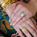 woman wearing 14K gold dome rings and other gold and diamond jewelry