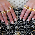 woman wearing multiple 18K diamond rings