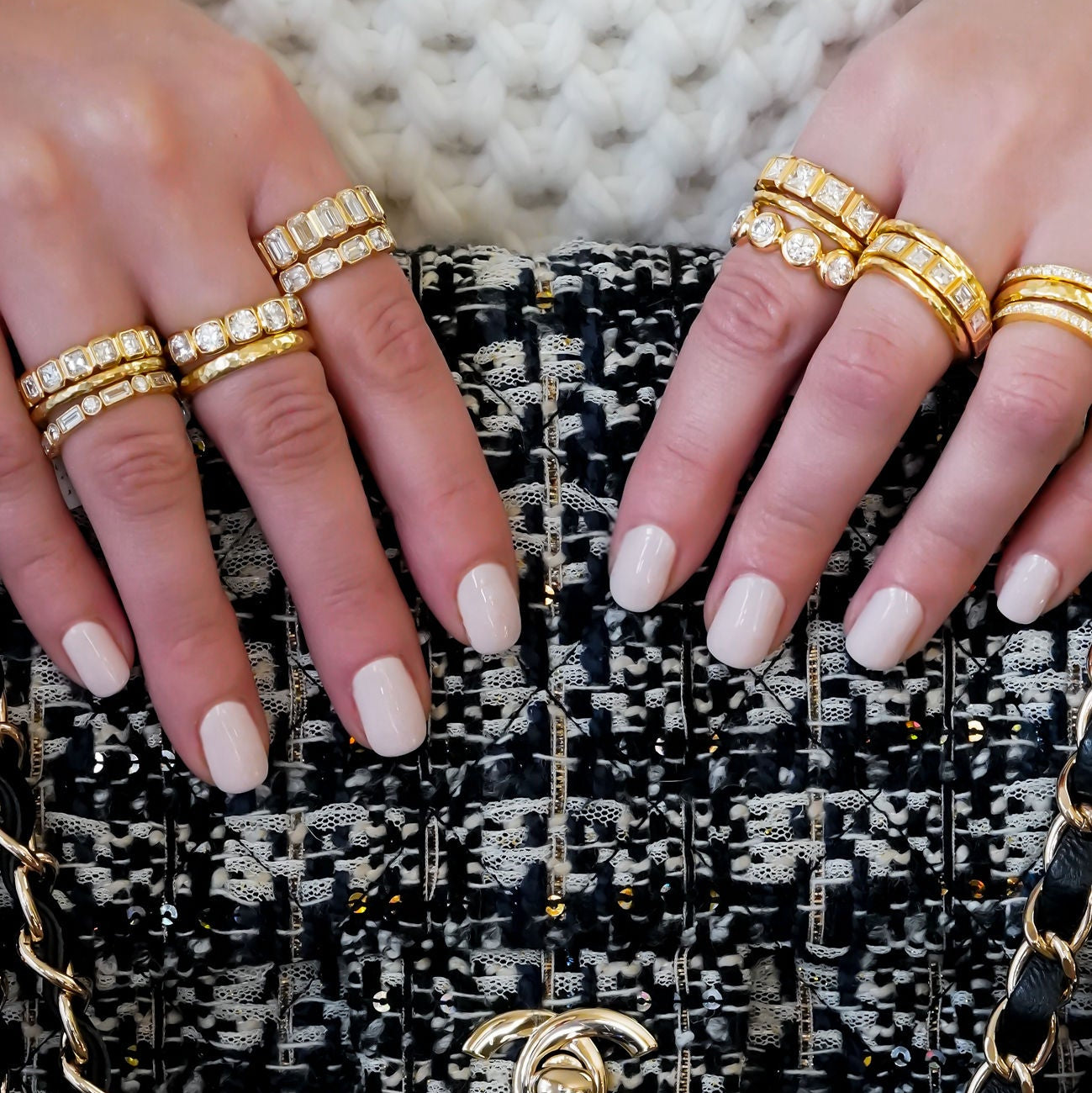 woman wearing multiple 18K yellow gold diamond band rings