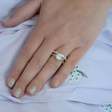 woman wearing round brilliant cut diamond ring designed by Laura Pearce