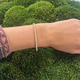 Close-up of a woman wearing a tennis bracelet