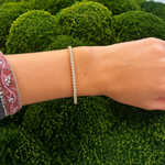 Close-up of a woman wearing a tennis bracelet