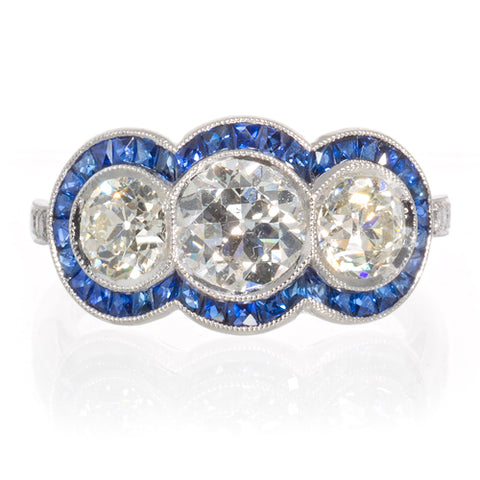 Platinum Three Stone Diamond Ring with Sapphire Halo