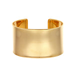 A wide cuff bracelet made of 14K yellow gold, with a smooth, polished finish.