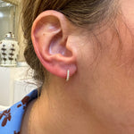 14K Yellow Gold Diamond Huggie Earrings on model