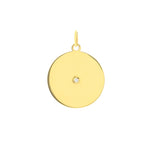 A round yellow gold disc pendant with a single diamond in the center, attached to a loop for a chain.