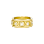 A 14K yellow gold ring with round and princess cut diamonds arranged in a band.