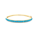 A 14K yellow gold bangle bracelet with turquoise beads