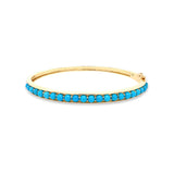 A 14K yellow gold bangle bracelet with turquoise beads