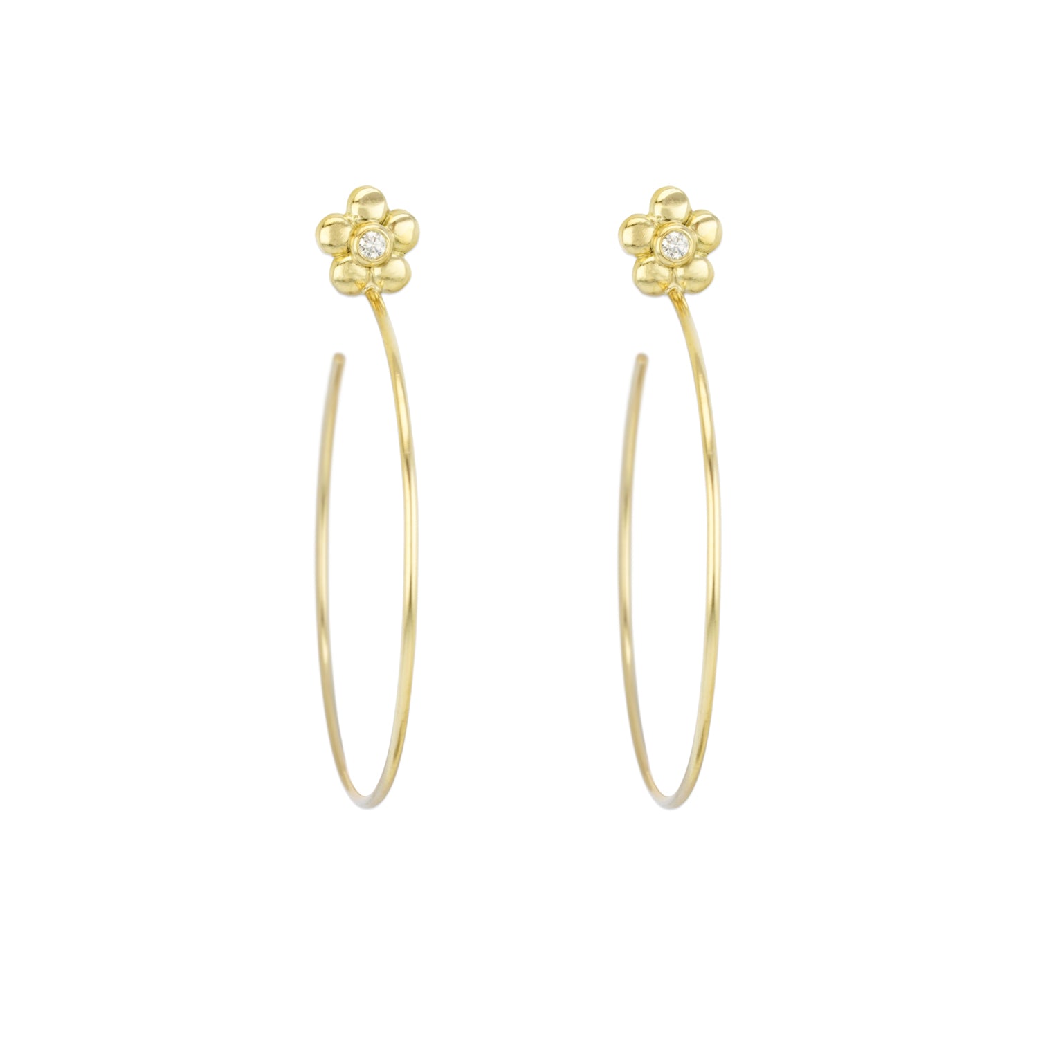 A pair of 18k yellow gold flower single diamond earrings, hanging against a white background.