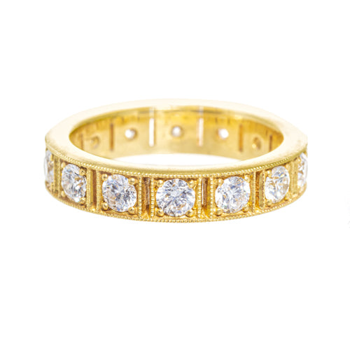 An 18k yellow gold band ring with multiple embedded diamonds