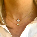 woman wearing two 18K yellow gold "Anderson" necklaces