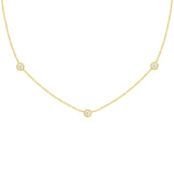 An 18k yellow gold necklace with a twist bezel diamond design featuring three diamonds by the yard.
