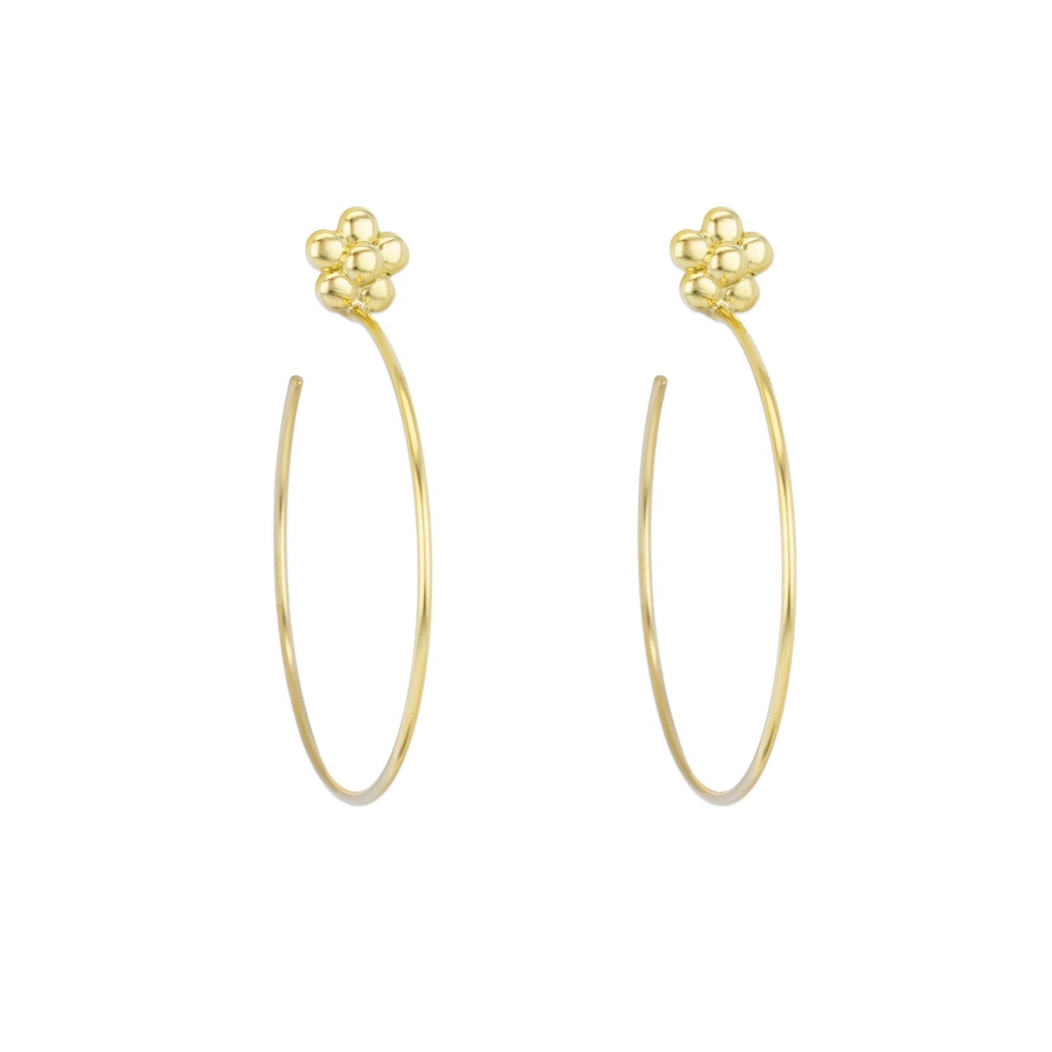 A pair of 18k yellow gold hoop earrings with a floral design at the top, against a white background.