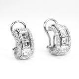 Pair of 18K white gold hoop earrings with diamond gemstones on a white background