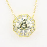 An 18K yellow gold pendant featuring a central diamond, surrounded by smaller clear diamonds set in a geometric pattern.
