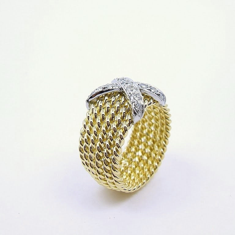 An 18kt yellow gold ring with a central X design diamond
