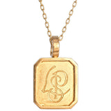 An 18kt yellow gold rectangular pendant with a vintage design engraved with initials