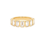 An 18K yellow gold band ring with bezel set baguette cut diamonds