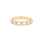 An 18K yellow gold band ring with emerald cut diamonds oriented east-west.