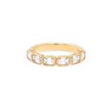 An 18K yellow gold band ring with emerald cut diamonds oriented east-west.