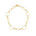 An 18k yellow gold link and toggle necklace on a white background
