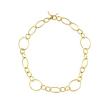 An 18k yellow gold link and toggle necklace on a white background