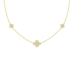 An 18k yellow gold necklace with multiple diamond stations arranged in a line on a white background.