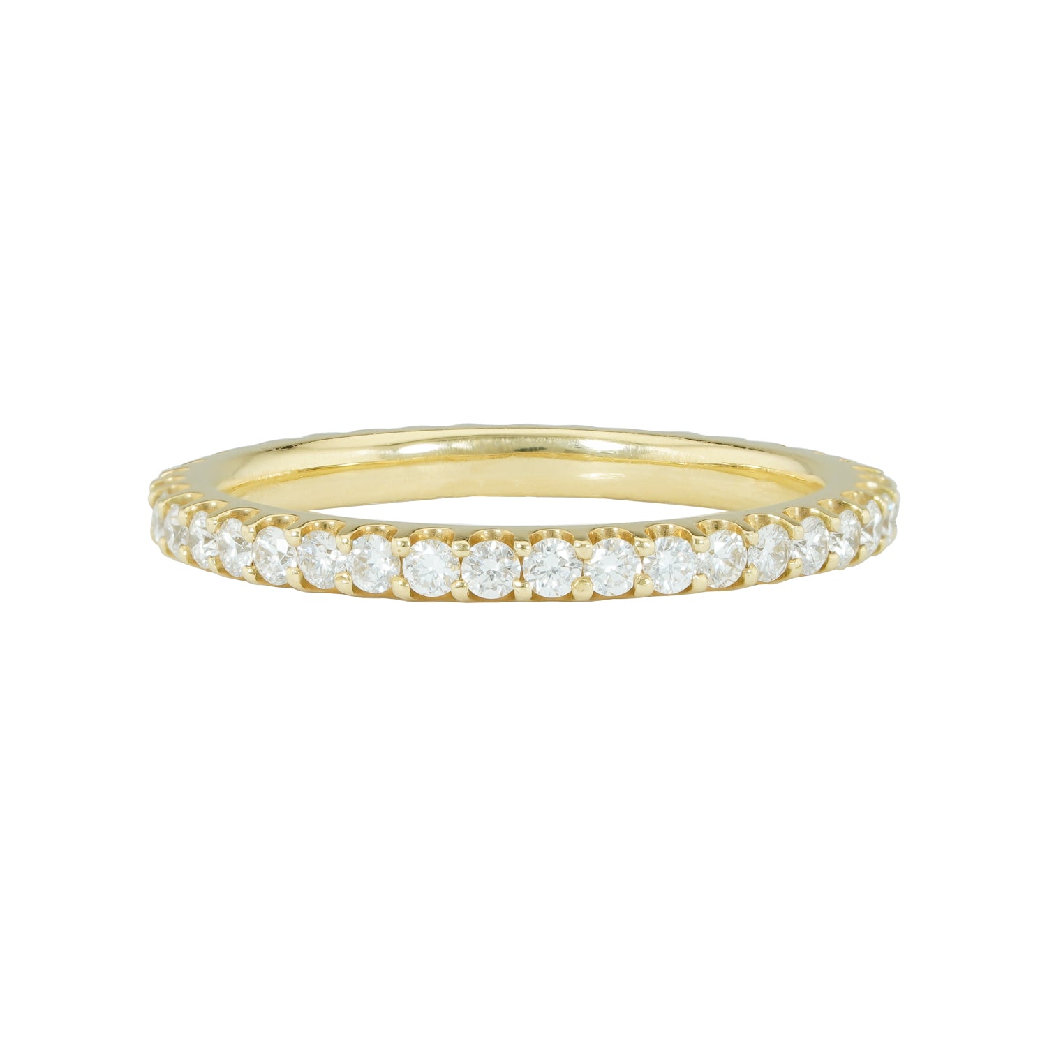 An 18K yellow gold eternity band with shared prong set diamonds