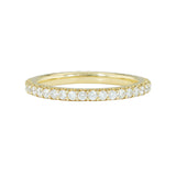 An 18K yellow gold eternity band with shared prong set diamonds