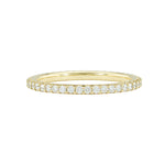 An 18k yellow gold eternity band with shared prong set diamonds