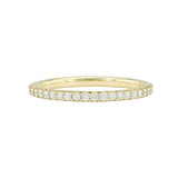 An 18k yellow gold eternity band with shared prong set diamonds