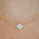 Close-up on-model shot of18k yellow gold necklace with an Anderson diamond design featuring four diamonds in a cluster