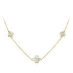 An 18k yellow gold necklace featuring three diamond station clusters with round diamonds set in a floral-like design on a white background.