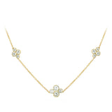 An 18k yellow gold necklace featuring three diamond station clusters with round diamonds set in a floral-like design on a white background.