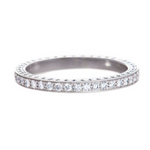 A platinum Art Deco bead set diamond eternity band with engraving on the side.