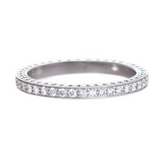A platinum Art Deco bead set diamond eternity band with engraving on the side.