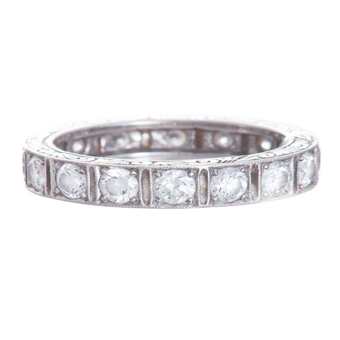 A platinum Art Deco style eternity band with square-shaped sections and round diamonds.