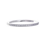 A platinum eternity band with bead set diamonds and milgrain