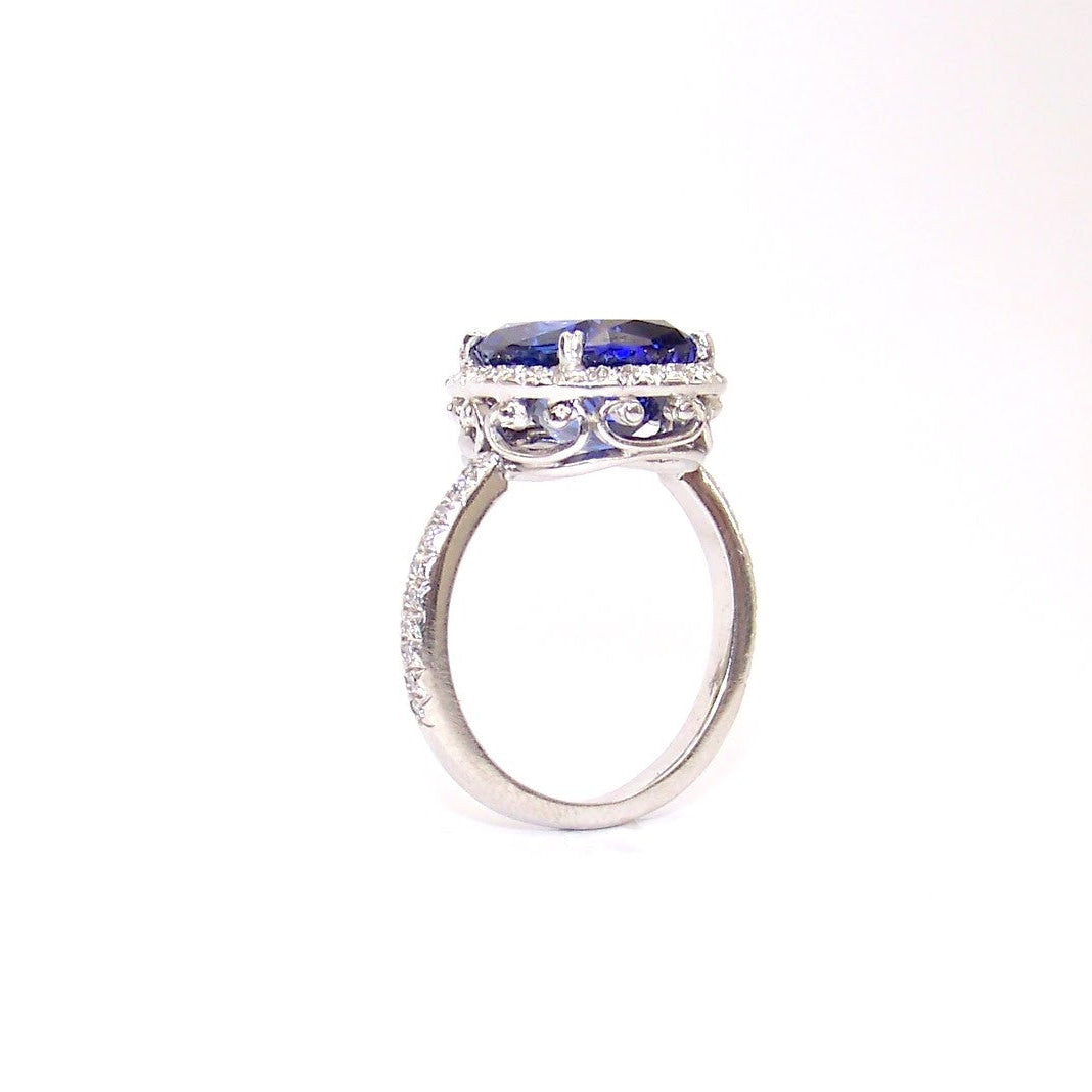 platinum ring with a blue sapphire gemstone on a white background