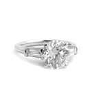 Custom designed Platinum Round Brilliant Cut Diamond with tapered baguette diamonds on the side 