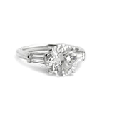 Custom designed Platinum Round Brilliant Cut Diamond with tapered baguette diamonds on the side 