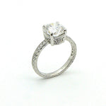 A platinum round diamond ring with a clear center diamond