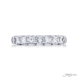 A platinum band ring with multiple diamonds set around its circumference.